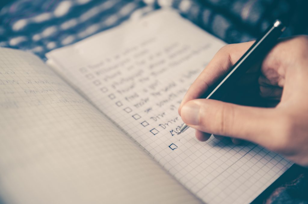 Person writing a checklist