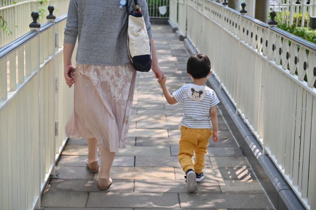 Missouri parent and child walking hand in hand
